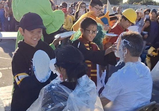 Panthers celebrate a successful fundraiser by giving a pie to the principal and teachers.
